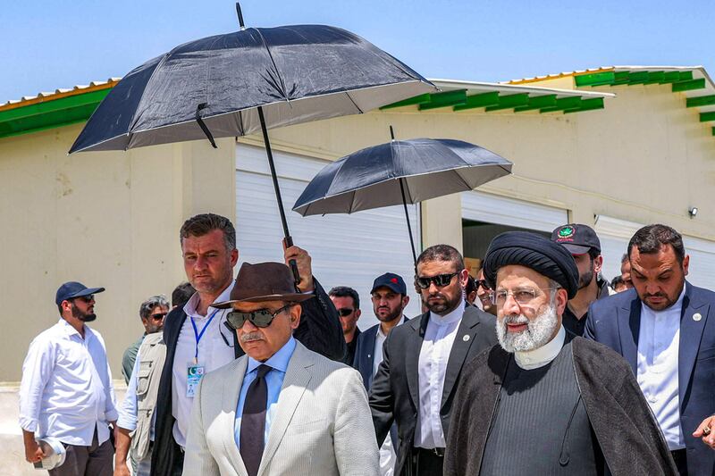 Iran's President Ebrahim Raisi, centre-right, and Pakistan's Prime Minister Shahbaz Sharif, centre-left, attending a ceremony to inaugurate a new border marketplace. AFP
