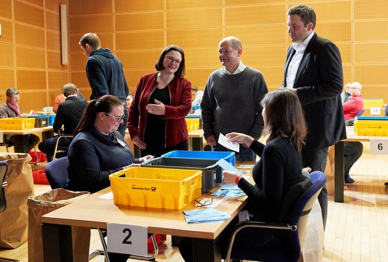 BERLIN, GERMANY - MARCH 3:  Chairman of the Social Democratic Party (SPD) parliamentary group Andrea Nahles (2-L), First Mayor of Hamburg and acting Leader Olaf Scholz (2-R) and Secretary General Lars Klingbeil (R) talk to the members of the SPD while they count votes for the government coalition agreement with the Christian Democratic Union (CDU) at the Willy-Brandt-Haus on March 3, 2018 in Berlin, Germany. The party's approximately 440,000 members are voting on whether to accept the coalition contract the party leadership recently hammered out with the German Christian Democrats (CDU/CSU) in order to create a new German government. The outcome is uncertain, as a large and vocal portion of the party is against the contract and seeks instead to keep the SPD in the opposition.  (Photo by Hayoung Jeon-Pool/Getty Images)