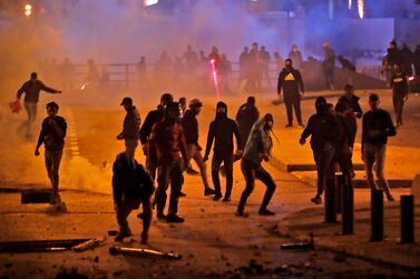 Supporters of the Lebanese political party Amal clash with riot police in central Beirut on December 12, 2019. AFP