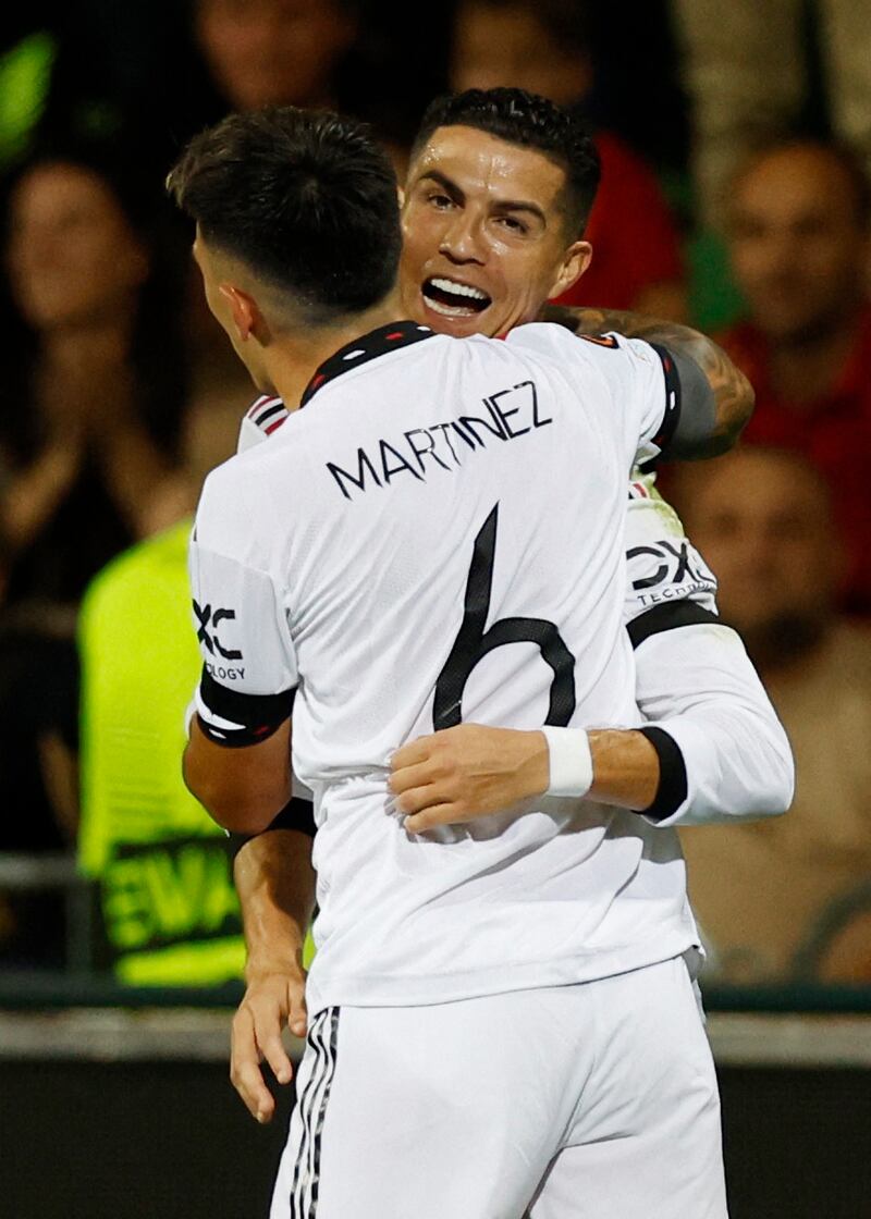 Cristiano Ronaldo celebrates scoring United's second goal with Lisandro Martinez. Action Images