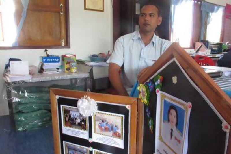 Malasen Arsen, the acting principal of Nongchik primary school, shows a memorial commemorating assassinated headmistress Nantana Kowchan, who killed by militants in December. Eric Randolph / The National