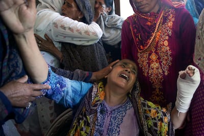 REFILE - CORRECTING GRAMMAR Family members comfort Sabar Jaan, as she mourns for her son, daughter-in-law and their children who were killed after a military aircraft on a training flight crashed in a built-up area in the garrison city of Rawalpindi, Pakistan, July 30, 2019. REUTERS/Saiyna Bashir     TPX IMAGES OF THE DAY