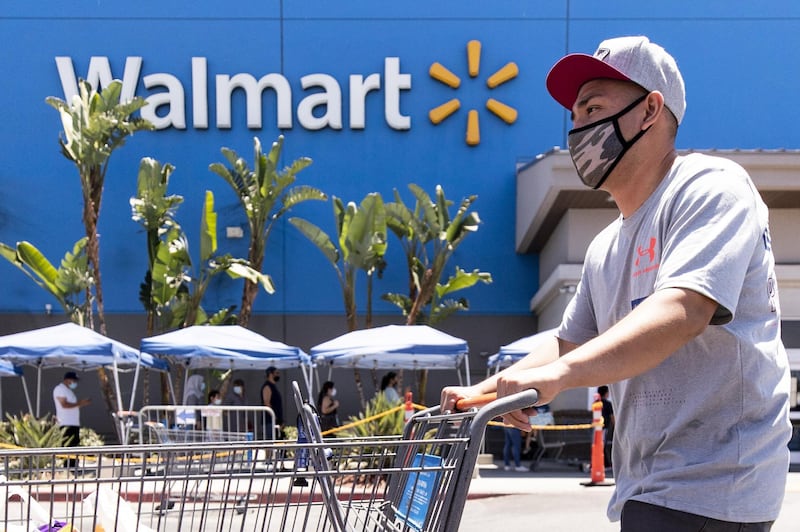 A Walmart shopper wears a mask as protection against the coronavirus as he leaves the supermarket in Burbank, California. The retailer announced it will require customers nationwide to wear face masks inside their stores from July20.  EPA