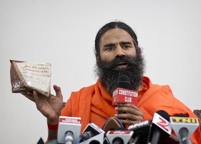 Indian yoga guru Baba Ramdev displays a packet of his medicine on May 1, 2015. Saurabh Das/AP Photo