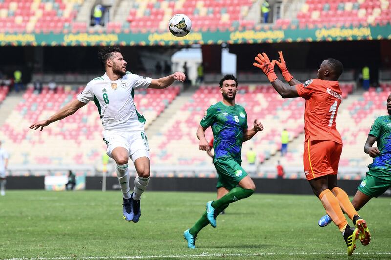 Algeria forward Youcef Belaili and Sierra Leone goalkeeper Mohamed Nbalie Kamara both go for a cross. AFP