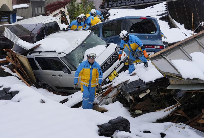 Police officers search for victims in a snow-covered residential area that was devastated by a tsunami after an earthquake, in Suzu, Ishikawa, Japan. Reuters
