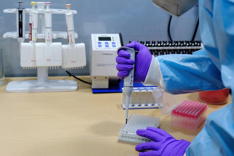 A healthcare worker uses a pipette to process Covid-19 test samples at the SpiceHealth Genome Sequencing Laboratory set up at the Indira Gandhi International Airport in New Delhi, India. Bloomberg
