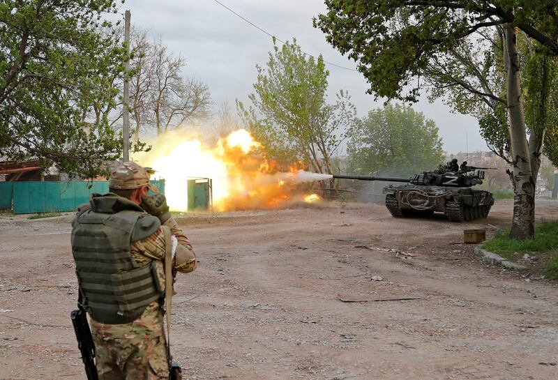 Service members of pro-Russian troops fire from a tank near the Azovstal steel plant in the southern port city of Mariupol on May 5. Reuters