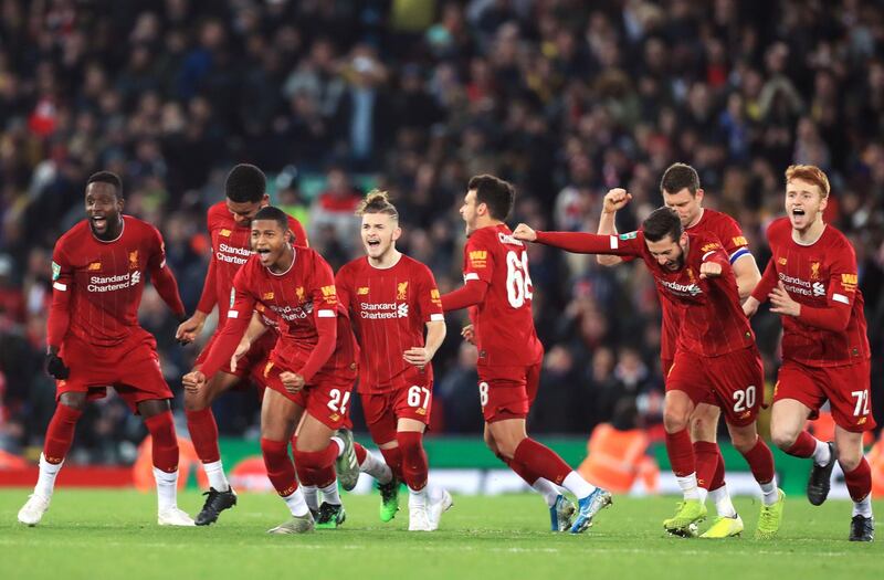 Liverpool players celebrate after winning the penalty shootout. PA