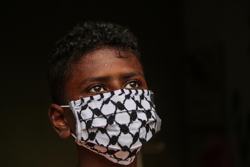 A boy wears one of Abu Ghabin's creations. EPA