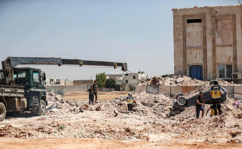 Members of the Syrian Civil Defence clear the rubble outside a health facility hit by a reported Russian air strike. AFP