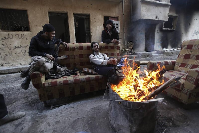 Free Syrian Army fighters sit around a fire in Deir Al Zor, eastern Syria. Those joining the battle against Bashar Al Assad include Western Muslims, reportedly from the UK, France, the United States, Canada, Australia and Scandinavia. Khalil Ashawi / Reuters





