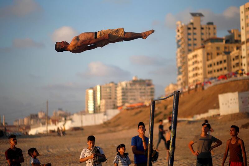 A Palestinian demonstrates his parkour skills on a beach in Gaza City Reuters