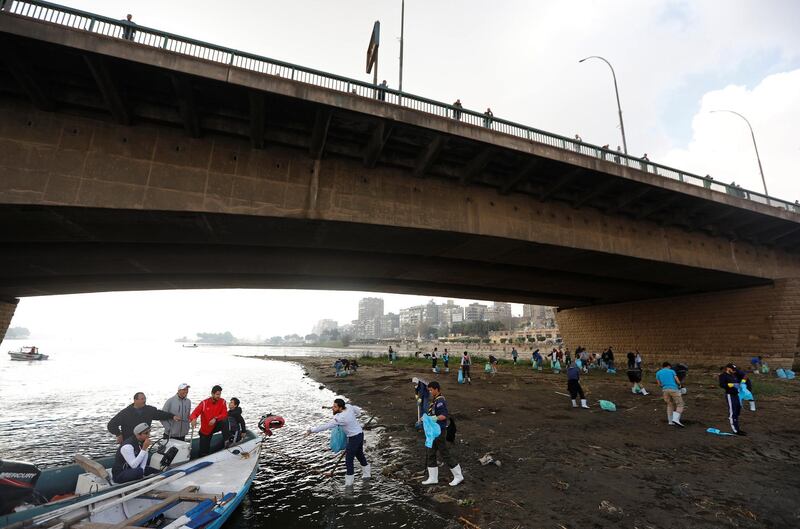 Egyptian youth volunteers collect waste as part of a campaign to clean up the Nile river in Cairo. Reuters