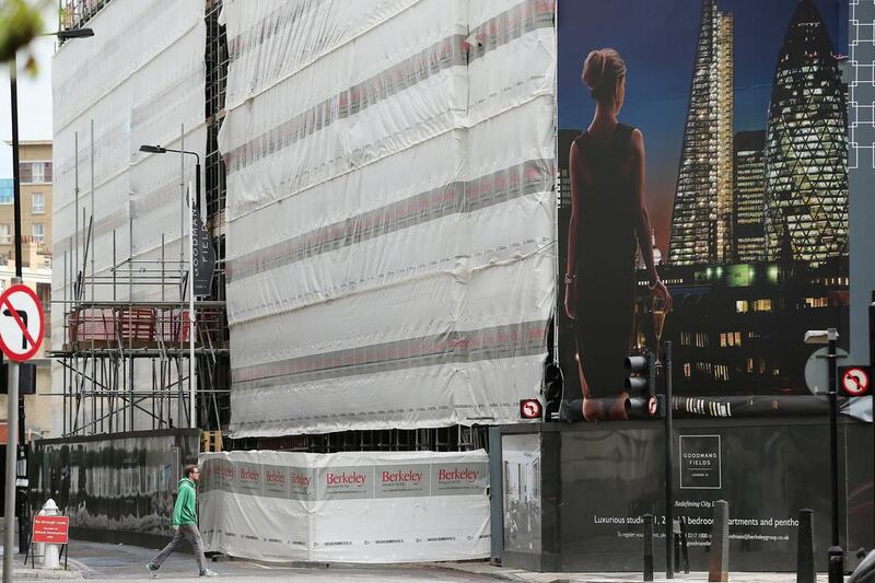 A man walks past a sign advertising new luxury apartments in London’s East End. The UK lender Nationwide said house prices in London in the first three months of the year were around 20 per cent higher than before the crisis. Dan Kitwood / Getty Images