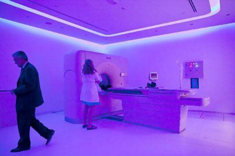 Registered Nurse Dorrie Emrick prepares the 64-slice CT scan machine for operation at the DNA Health Centre near the St. Regis Hotel in Abu Dhabi.