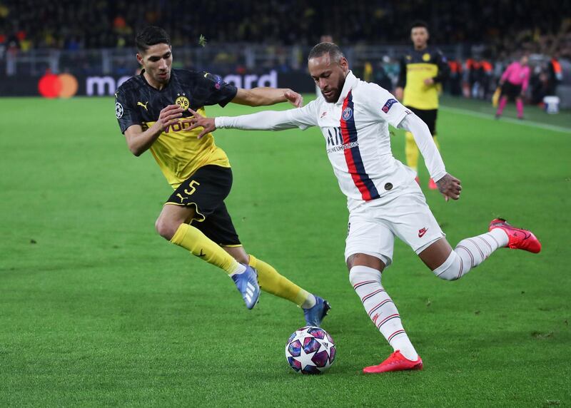 DORTMUND, GERMANY - FEBRUARY 18: Neymar of Paris Saint-Germain is challenged by Achraf Hakimi of Dortmund during the UEFA Champions League round of 16 first leg match between Borussia Dortmund and Paris Saint-Germain at Signal Iduna Park on February 18, 2020 in Dortmund, Germany. (Photo by Alex Grimm/Getty Images)