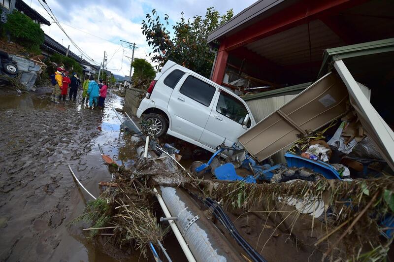 A car sits next to a badly damaged home in Nagano after Typhoon Hagibis hit Japan on October 12 unleashing high winds, torrential rain and triggered landslides and catastrophic flooding. The death toll from the disaster has risen steadily, and the national broadcaster early on October 15 said 58 people had been killed, according to authorities, while more than a dozen were still missing. AFP