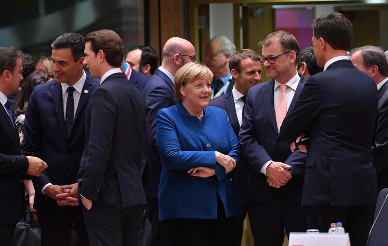 Germany's Chancellor Angela Merkel (C) and Finland's Prime Minister Juha Sipila (2R) speak with other leaders as they attend a summit of European Union leaders in which Brexit negotiations are expected to be top of the agenda at the European Council in Brussels on October 17, 2018.  / AFP / Emmanuel DUNAND

