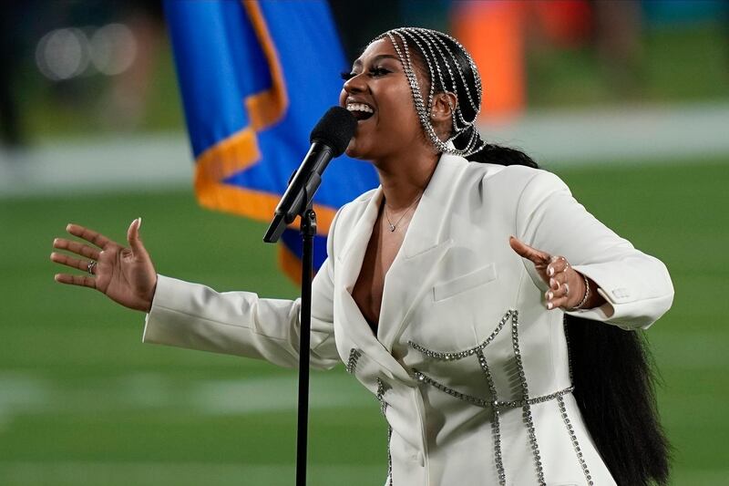 Jazmine Sullivan performs in a cream blazer and bejewelled headpiece. AP