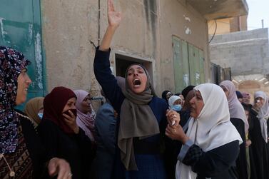 Family members and others mourn during the funeral of a teenager authorities say was shot by Israeli soldiers in the West Bank. EPA