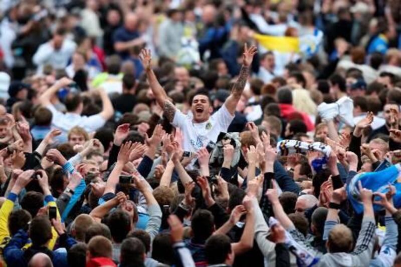 Leeds United's Bradley Johnson (centre, arms raised) is mobbed by fans after the final whistle as they celebrate their sides promotion