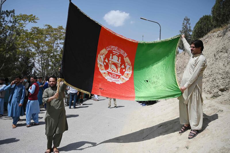 Afghans celebrate the 102nd Independence Day of Afghanistan with the national flag in Kabul. AFP