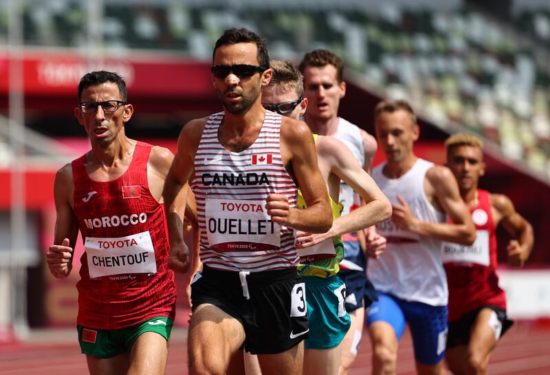 Amine Chentouf of Morocco and Guillaume Ouellet of Canada in action in the men's 5,000m T12. Reuters