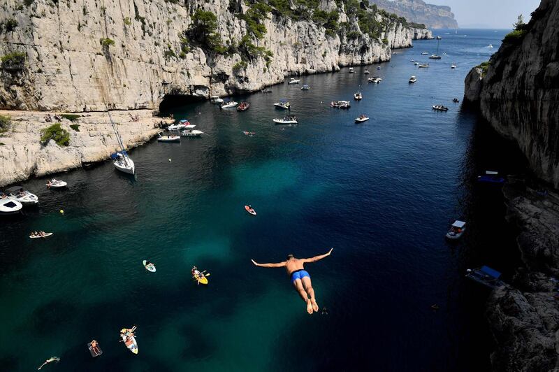 Lionel Franc, a 48 years old Frenchman, dives from a cliff in the calanques of Cassis, southern France. - Lionel is the holder of the world record of high-diving. AFP