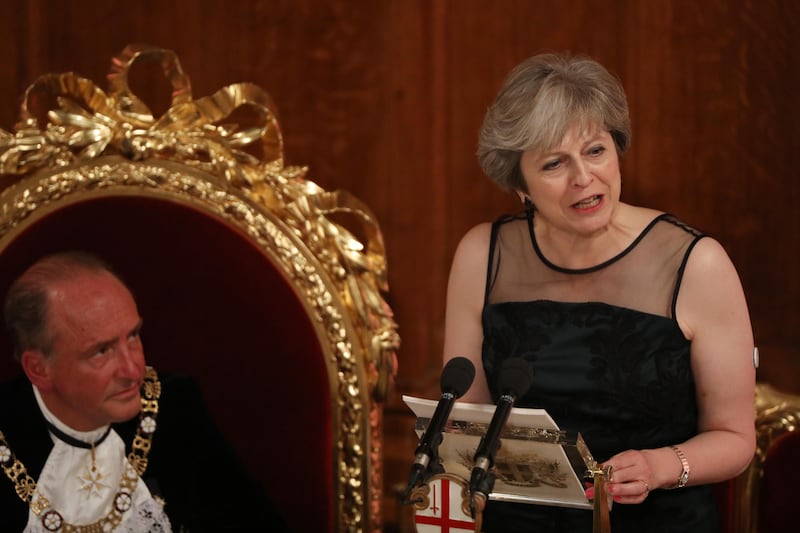 Theresa May, U.K. prime minister, right, speaks as Charles Bowman, Lord Mayor of the City of London, listens during the annual Lord Mayor's Banquet at the Guildhall, in the square mile financial district of the City of London, U.K., on Monday, Nov. 13, 2017. The pound dropped the most in a week as U.K. Prime Minister Theresa May faced fresh challenges to her leadership and the European Union cast doubt on the prospect of a December Brexit deal. Photographer: Luke MacGregor/Bloomberg