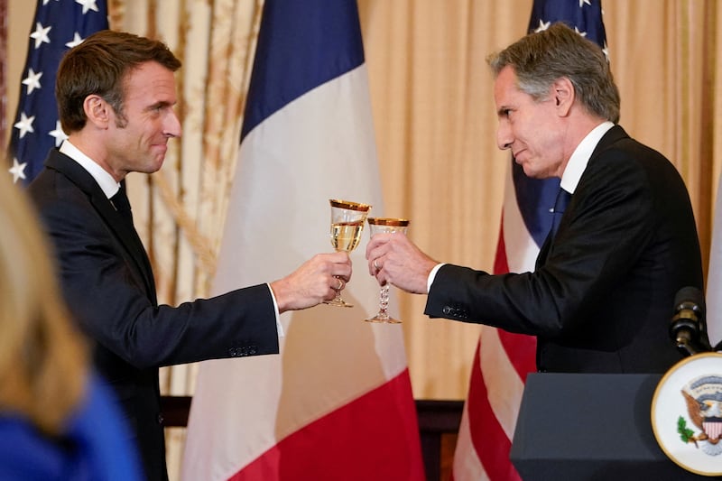 French President Emmanuel Macron and Secretary of State Antony Blinken toast each other during a luncheon at the State Department in Washington. Reuters