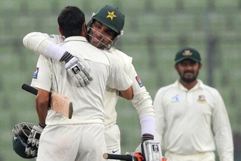 Pakistan's cricket captain Misbah-ul-Haq, second from left, gives teammate Younis Khan a hug after their squad made quick work of Bangladesh to win the Test series 2-0.