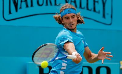 Stefanos Tsitsipas of Greece returns a ball to to Kyle Edmund of Britain during their singles match at the Queens Club tennis tournament in London, Thursday, June 20, 2019. (AP Photo/Frank Augstein)