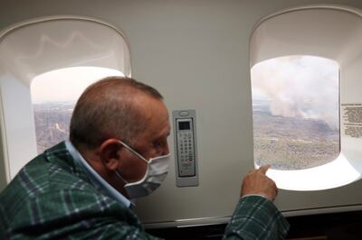 Turkey's President Recep Tayyip Erdogan views the wildfires in Manavgat, Antalya, from the air on July 31, 2021. Turkish Presidency via AP