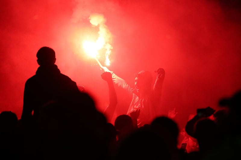 Liverpool fans celebrate outside The Kop stand at Anfield. Getty