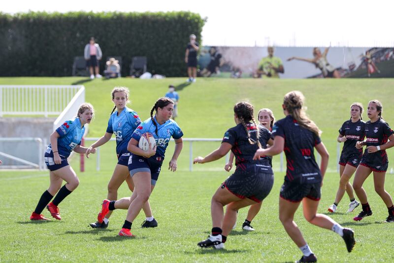 Dubai Exiles Girls U19 A (in black) in action against Dubai Warriors 2 U19G at the HSBC Rugby Festival, The Sevens Stadium in Dubai. Photos by Khushnum Bhandari / The National