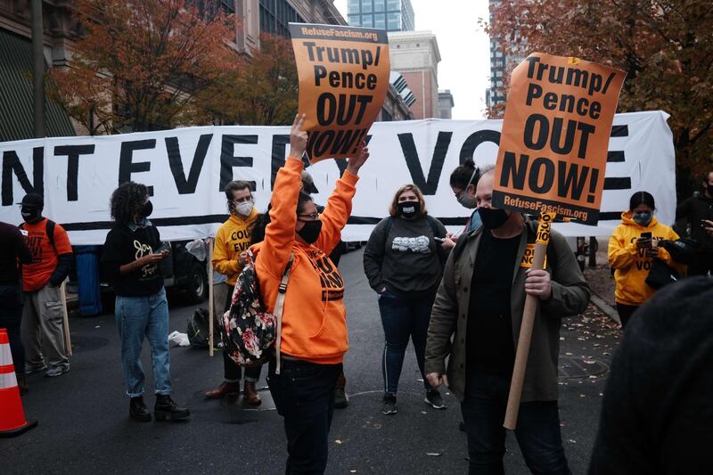 Protesters outside of the Philadelphia Convention Centre. Joe Biden took the lead in the vote count on Friday morning from President Trump, bringing him one step closer to winning the election. AFP