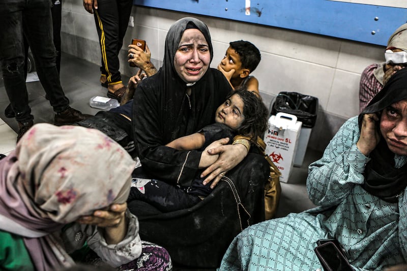 Palestinians wait for treatment at Al Shifa Hospital in Gaza city after being wounded in an air strike that killed at least 500 people at Al Ahli Hospital. AP