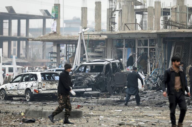 Afghan security personnel inspect the site of a bombing attack in Kabul, Afghanistan, Sunday, Dec. 20, 2020. The strong car bomb explosion rocked the capital Kabul city on Sunday morning, killing multiple people, said a government official. (AP Photo/Rahmat Gul)