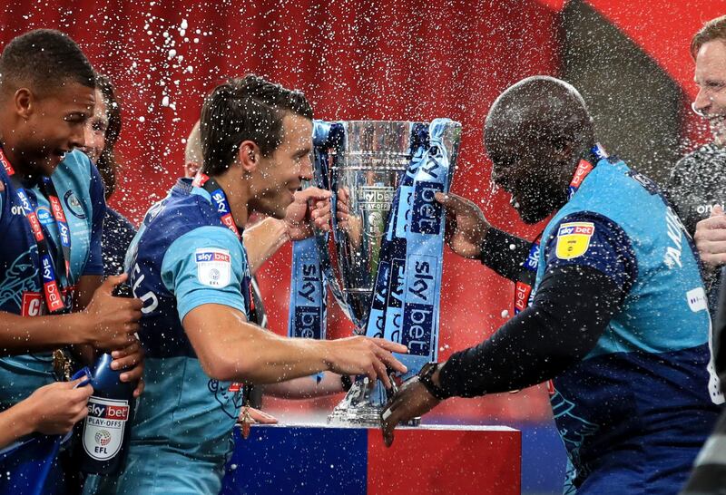 Wycombe Wanderers' Matt Bloomfield (left) and Adebayo Akinfenwa prepare to lift the trophy. PA