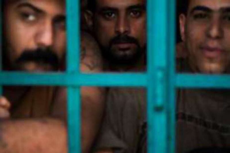 Inmates inside their cells at Kut Central Prison in Wasit province, Iraq, Tuesday, October 21, 2008.  The prison was designed as a temporary holding centre for 150 detainees but routinely contains more than 250, some on death row, others serving long sentences.  Overcrowding is exacerbated by a slow and corrupt legal system, according to US officials and former prisoners.     *** Local Caption ***  prison 2.jpg