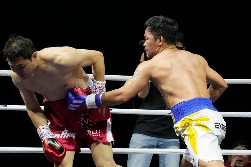 Manny Pacquiao lands a body shot on DK Yoo during the fourth round of their exhibition match. AP