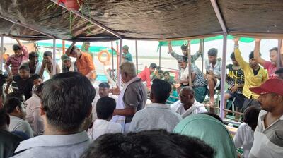 Pramod Manjhi, a union leader, is surrounded by protesting boatmen. Tarushi Aswani for The National