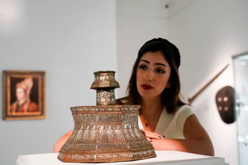 A gold and silver-inlaid brass candlestick produced in Iraq is the highest valued item on auction and is estimated to fetch between £2mn to £3mn. AP Photo