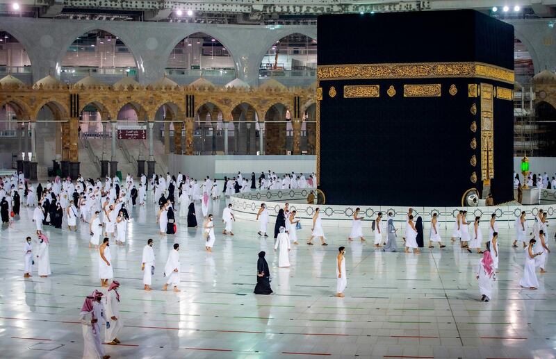 Saudis and foreign residents circumambulate the Kaaba (Tawaf) in the Grand Mosque complex in the holy city of Makkah, as authorities partially resume the year-round Umrah for a limited number of pilgrims amid extensive health precautions after a seven-month coronavirus hiatus. Saudi Ministry of Hajj and Umra / AFP