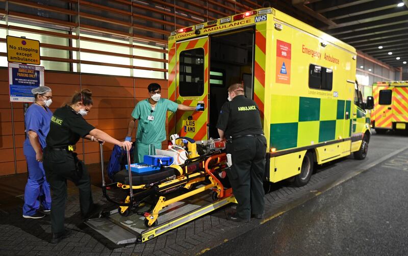 NHS staff stand outside the Royal London hospital in London. EPA