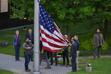 Members of US diplomatic mission in Ukraine raise the US national flag for the first time after return to the U. S embassy in Kyiv, Ukraine, 18 May 2022.  The US embassy in Ukraine resumed operations on 18 May following its closure and the evacuation of its staff in mid February under the threat of a Russian invasion.  On 24 February, Russian troops entered Ukrainian territory starting a conflict that has provoked destruction and a humanitarian crisis.   EPA / OLEG PETRASYUK