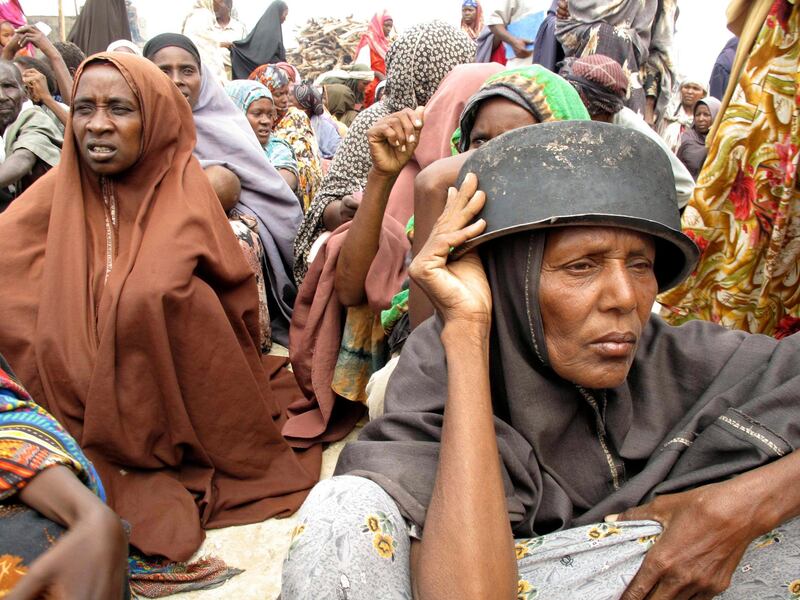 Somalis displaced by famine wait to receive rations at a displaced camp in Mogadishu, Somalia, Monday, July 25, 2011. Some thousands of people have arrived in Mogadishu seeking aid and The World Food Program executive director Josette Sheeran said Saturday they can't reach the estimated 2.2 million Somalis in desperate need of aid who are in militant-controlled areas of Somalia.(AP Photo/Mohamed Sheikh Nor)                