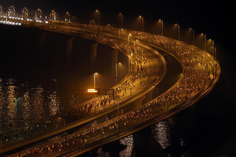 Participants run along the Bandra-Worli sea link over the Arabian Sea during Tata Mumbai Marathon, in Mumbai, India. Reuters