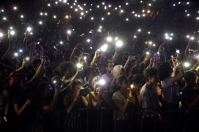 epaselect epa06970186 People rise up their illuminated cell phones as Lebanese alternative rock band Mashrou' Leila perform on stage during a concert at the Amchit International Festival in Amchit north of Beirut, Lebanon, 24 August 2018. The festival runs from 23 to 26 August. Mashrou' Leila is a Lebanese five-member alternative rock band, formed in Beirut, Lebanon in 2008 as a music workshop at the American University of Beirut (AUB).  EPA/WAEL HAMZEH